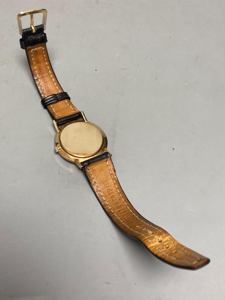 A gentleman's 1960's 9ct gold Longines manual wind wrist watch, on associated leather strap, case diameter ex. crown, 33mm, gross weight 24,4 grams.